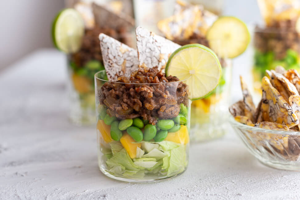 Asiatischer Schichtsalat im Glas mit Edamame, Mango und Sweet Chili Sauce fürs Partybufett.