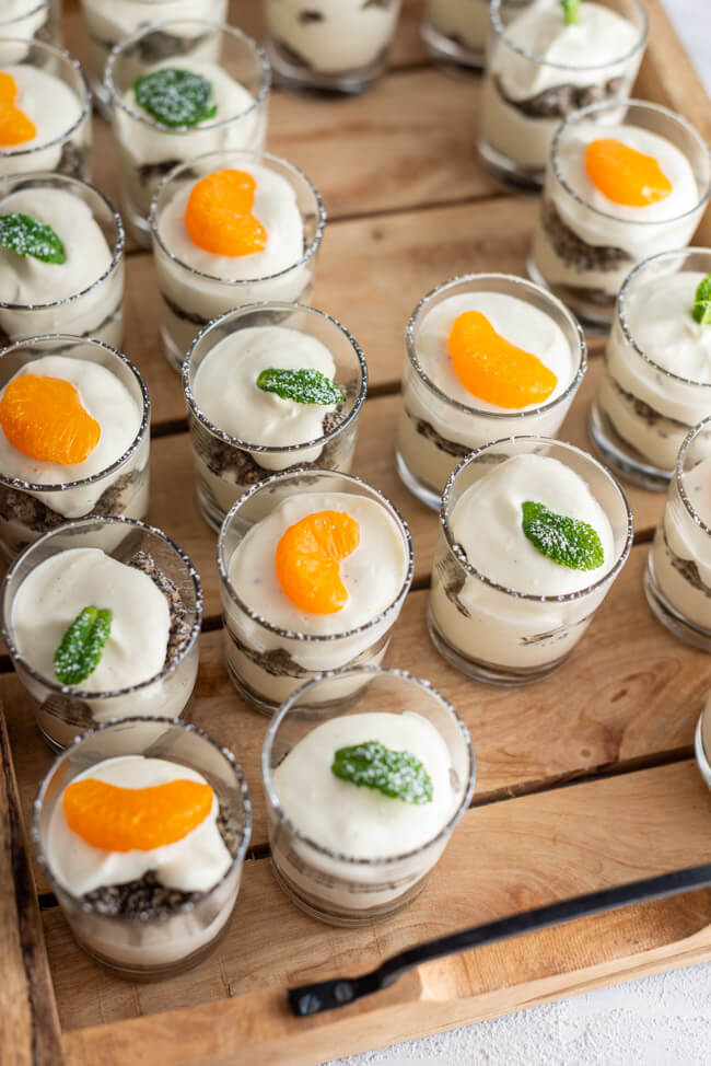 Dessert in Gläschen auf Holztablett.