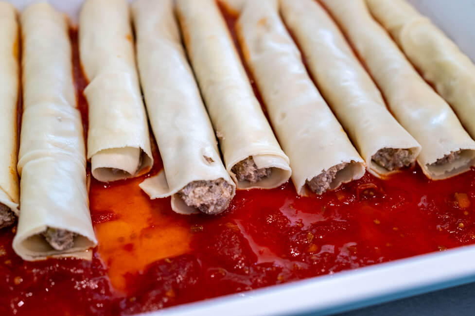 Frisch gefüllte Cannelloni im Backblech auf Tomatensauce