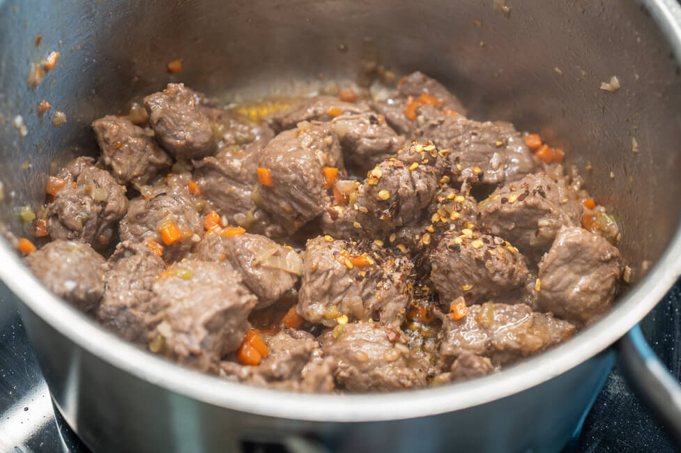 Rindfleisch mit Chiliflocken wird im Topf angebraten