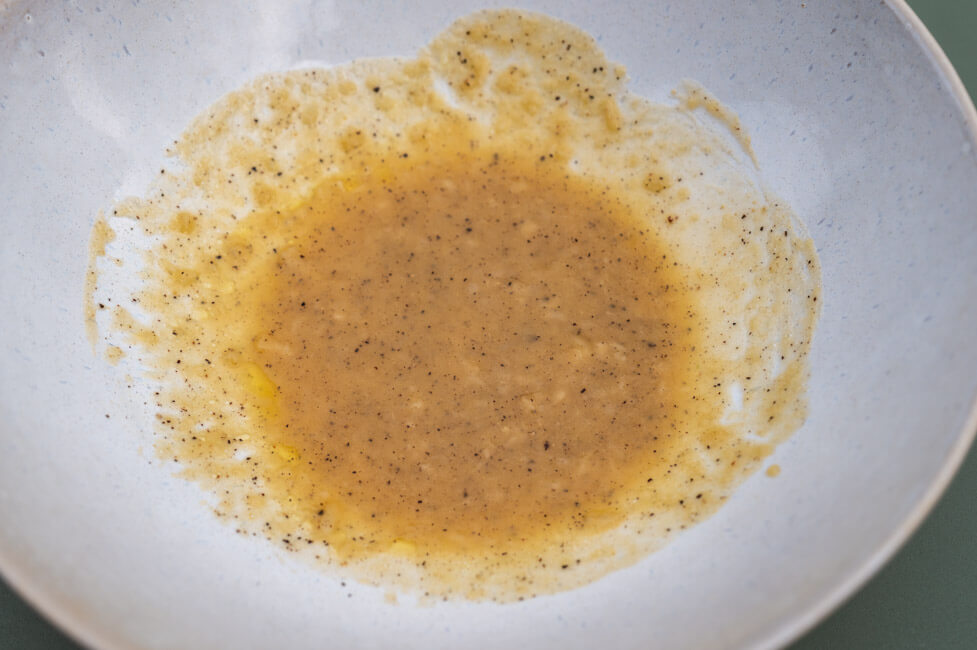 Knoblauch-Senf-Dressing in weißer Porzellanschüssel